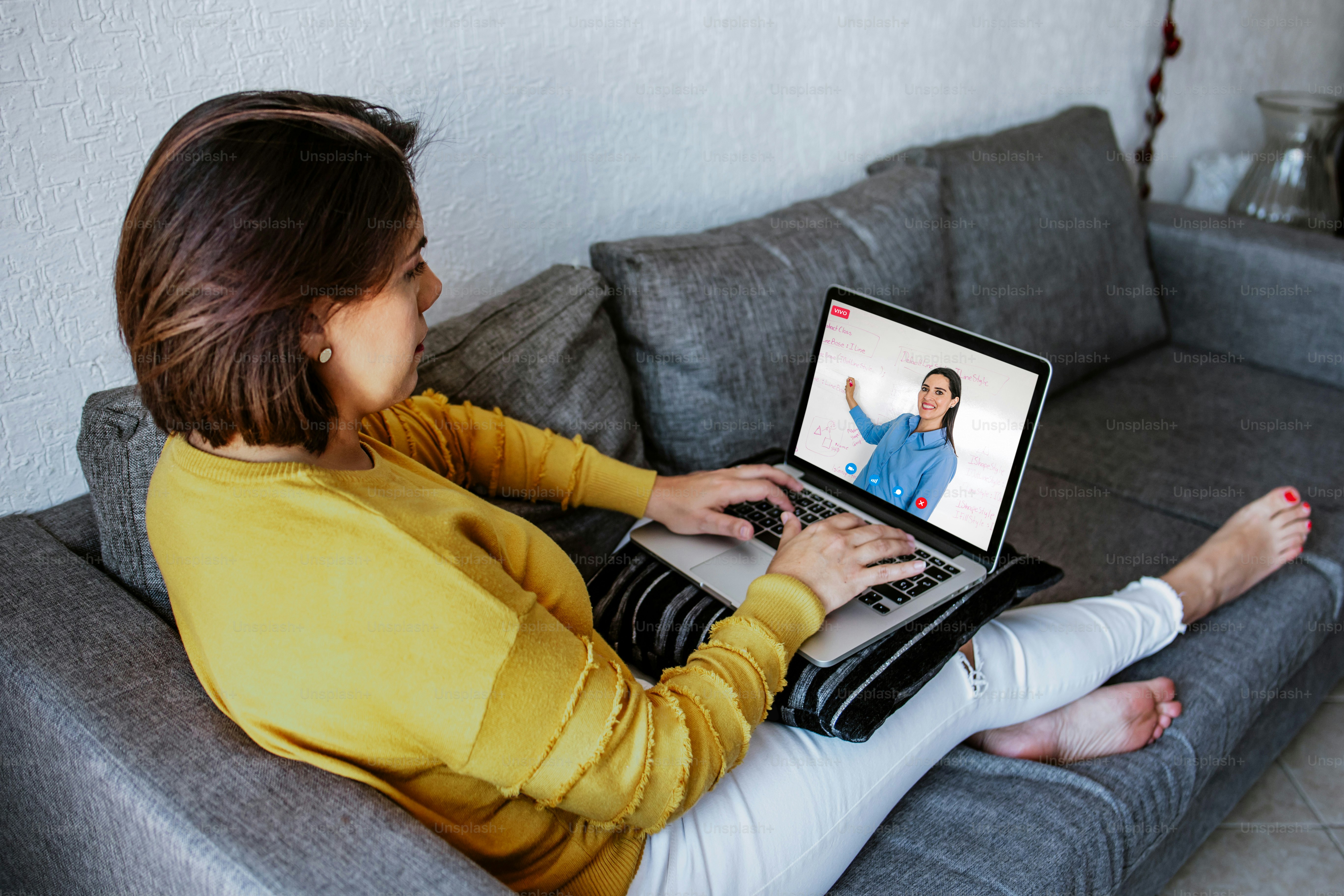 latin woman student watching lesson online and studying from home in Mexico city