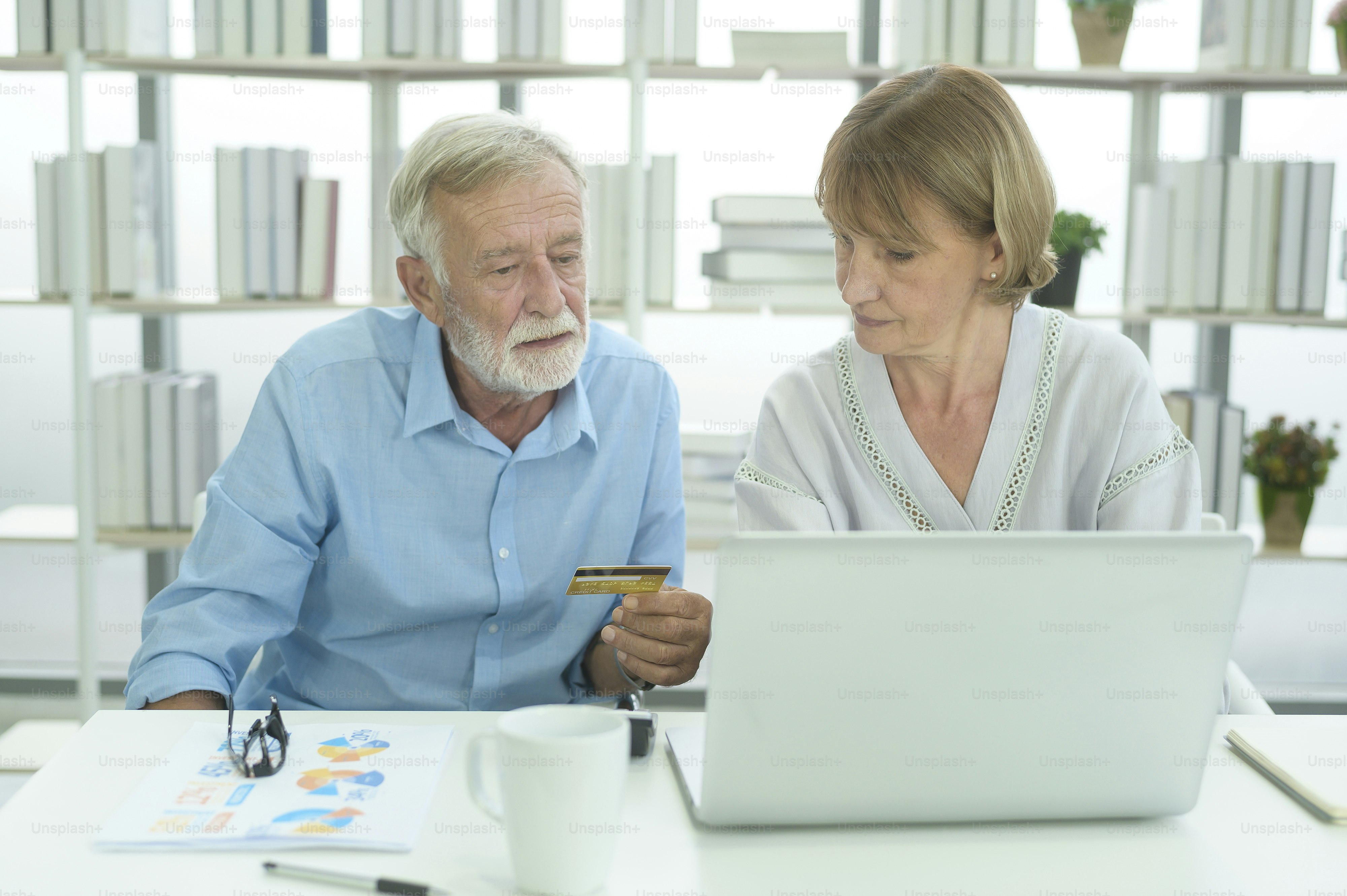 Caucasian senior people holding credit card, shopping online concept ...
