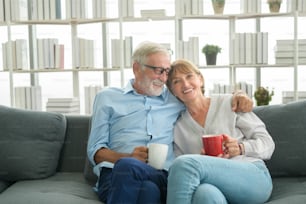 Felice coppia di anziani caucasici stanno bevendo caffè a casa, rilassante e concetto di assistenza sanitaria.