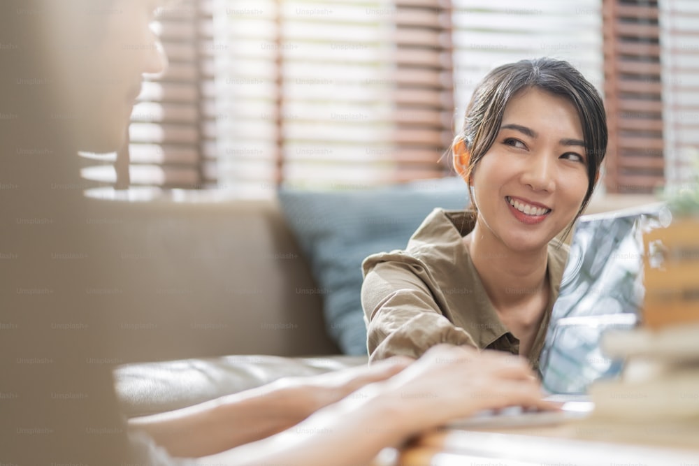 asian female family lifestyle weekend,asian female housewife sit relax conversation with positive feeling consult with husband smiling cheerful together in living room at home