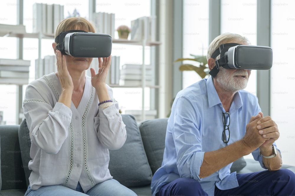 A Caucasian senior couple wearing vr box at home