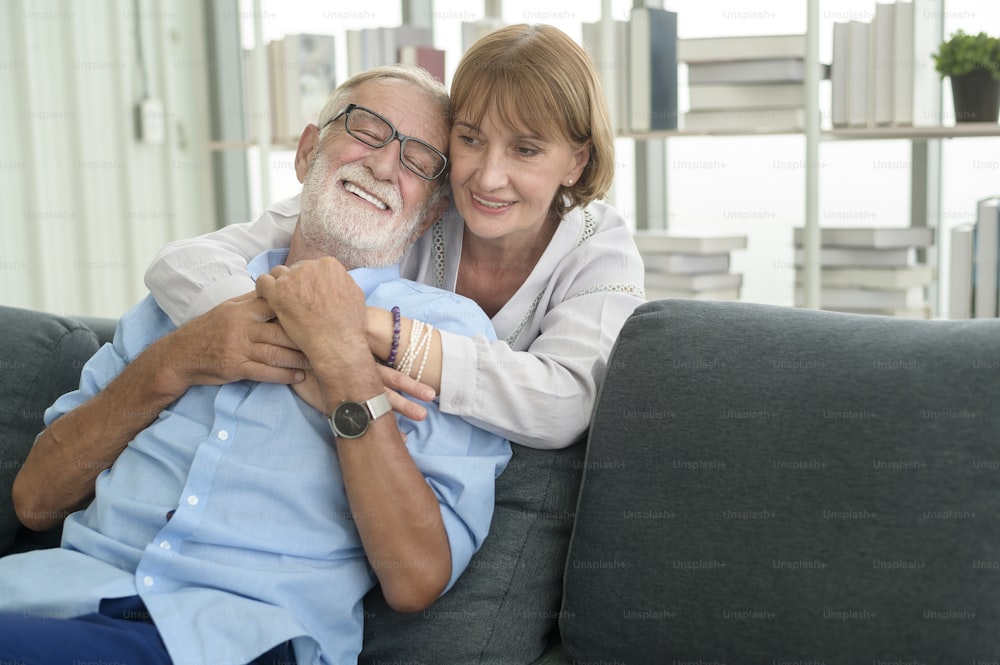 Happy Caucasian senior couple relaxing in living room  at home