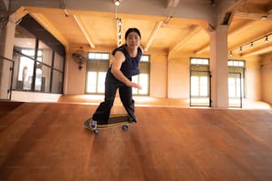 young woman person in sport skate lifestyle, happy teen girl having fun with skateboard in sport gym, hipster fashion urban activity trendy