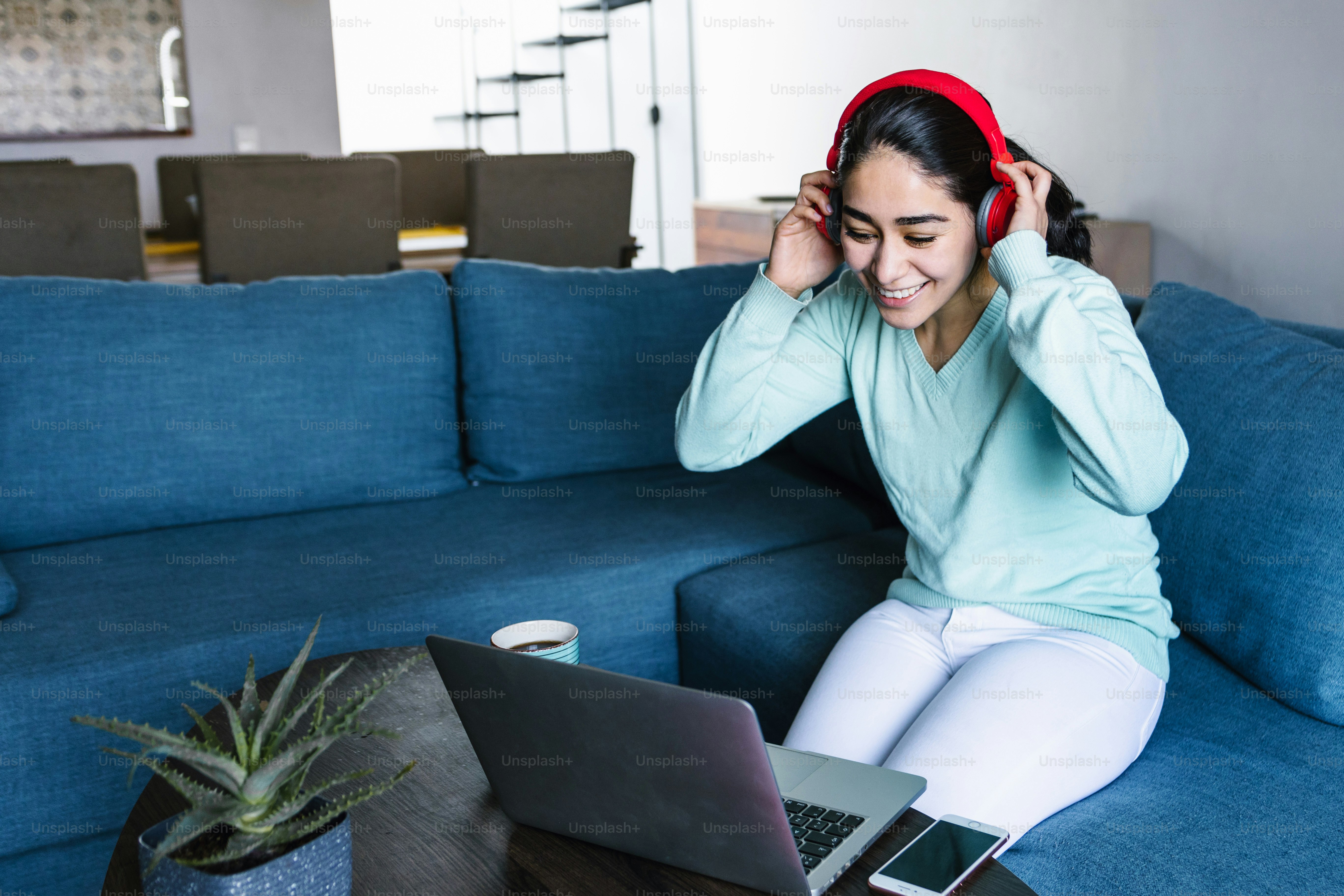 Latin woman in front of her laptop staring at the screen, bored, sleepy ...