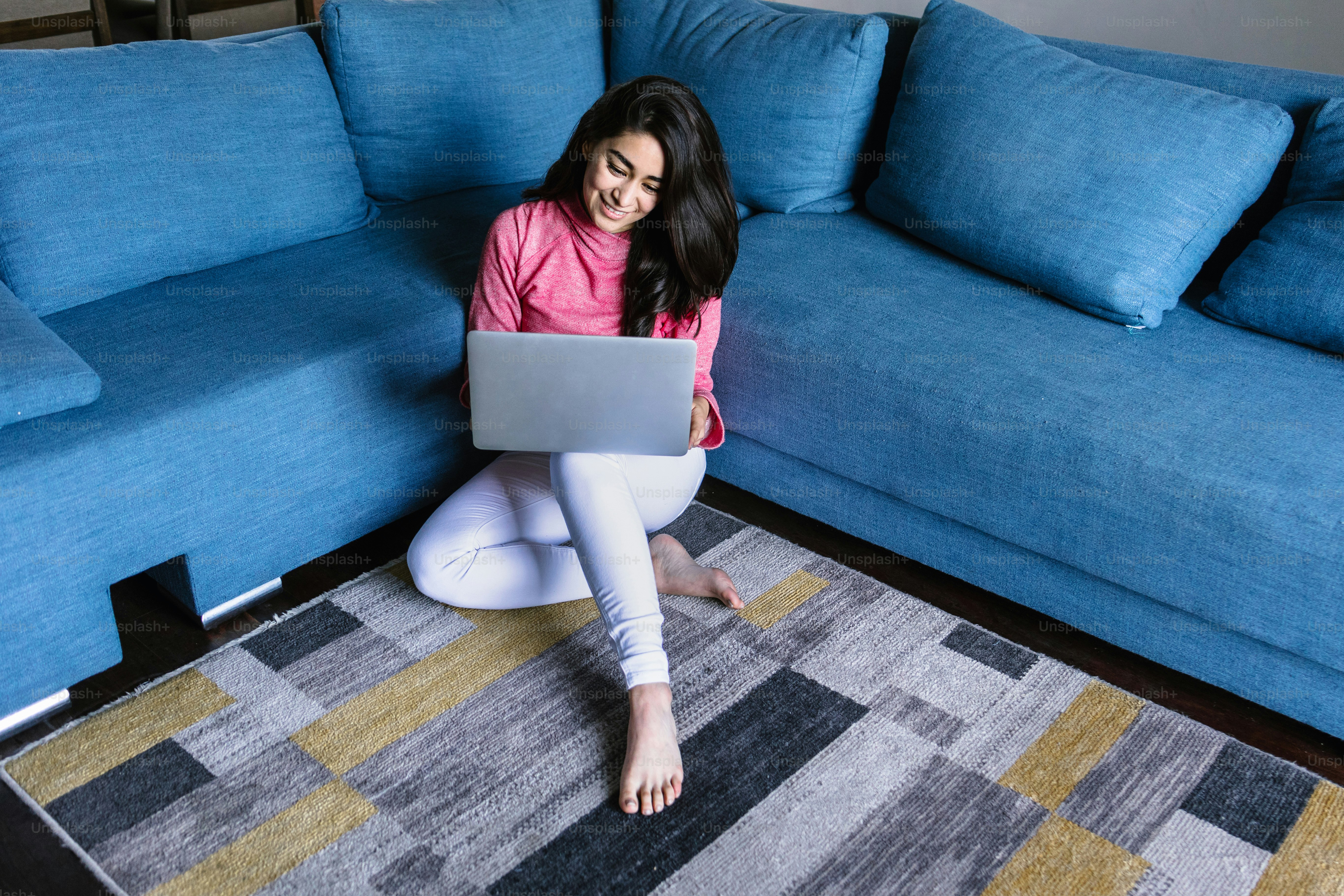 Latin woman in front of her laptop staring at the screen, bored, sleepy ...