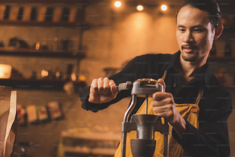 Asian hipster barista working to make a coffee by slow bar process, coffee filter or drip brewing is a vintage style hot beverage drink having fresh aroma caffeine and serve about black dark aromatic