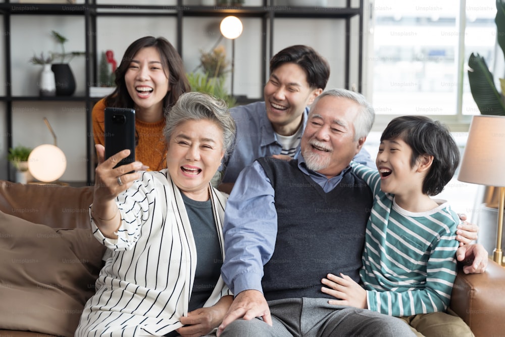 Asian big family taking selfie together at home