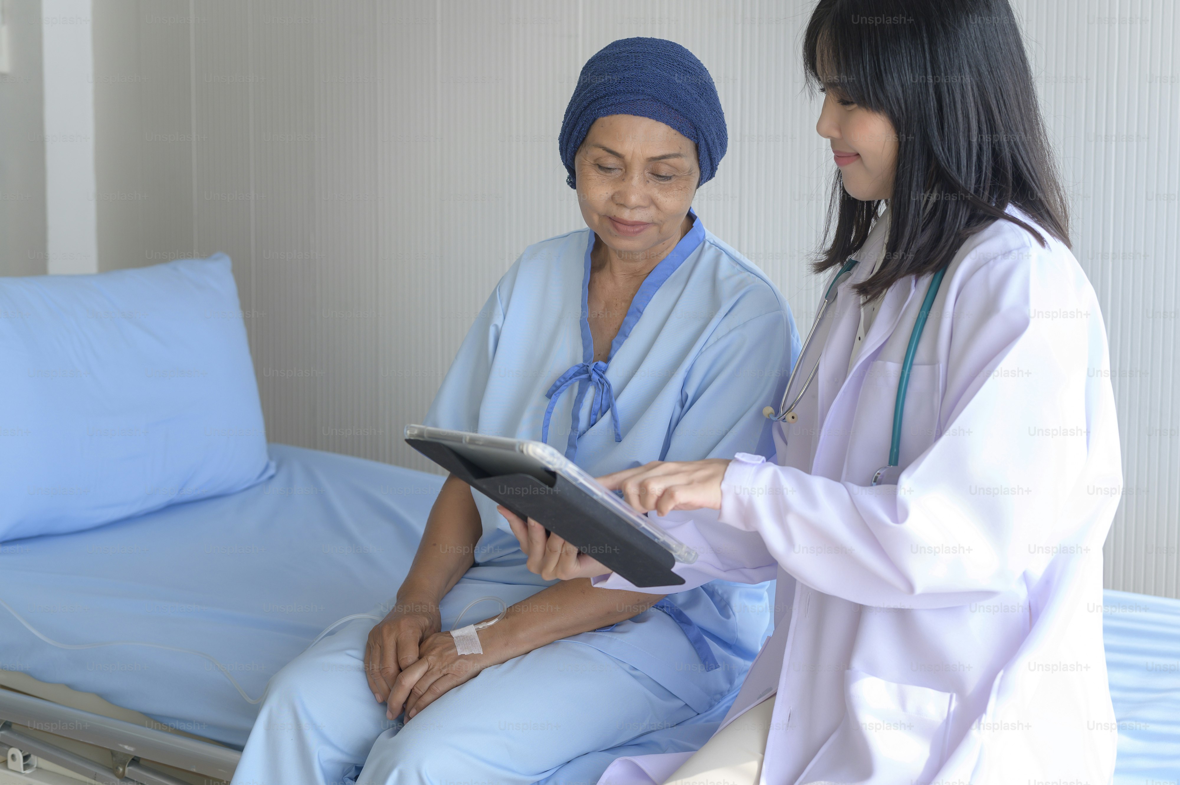 Cancer patient woman wearing head scarf after chemotherapy consulting and visiting doctor in hospital..