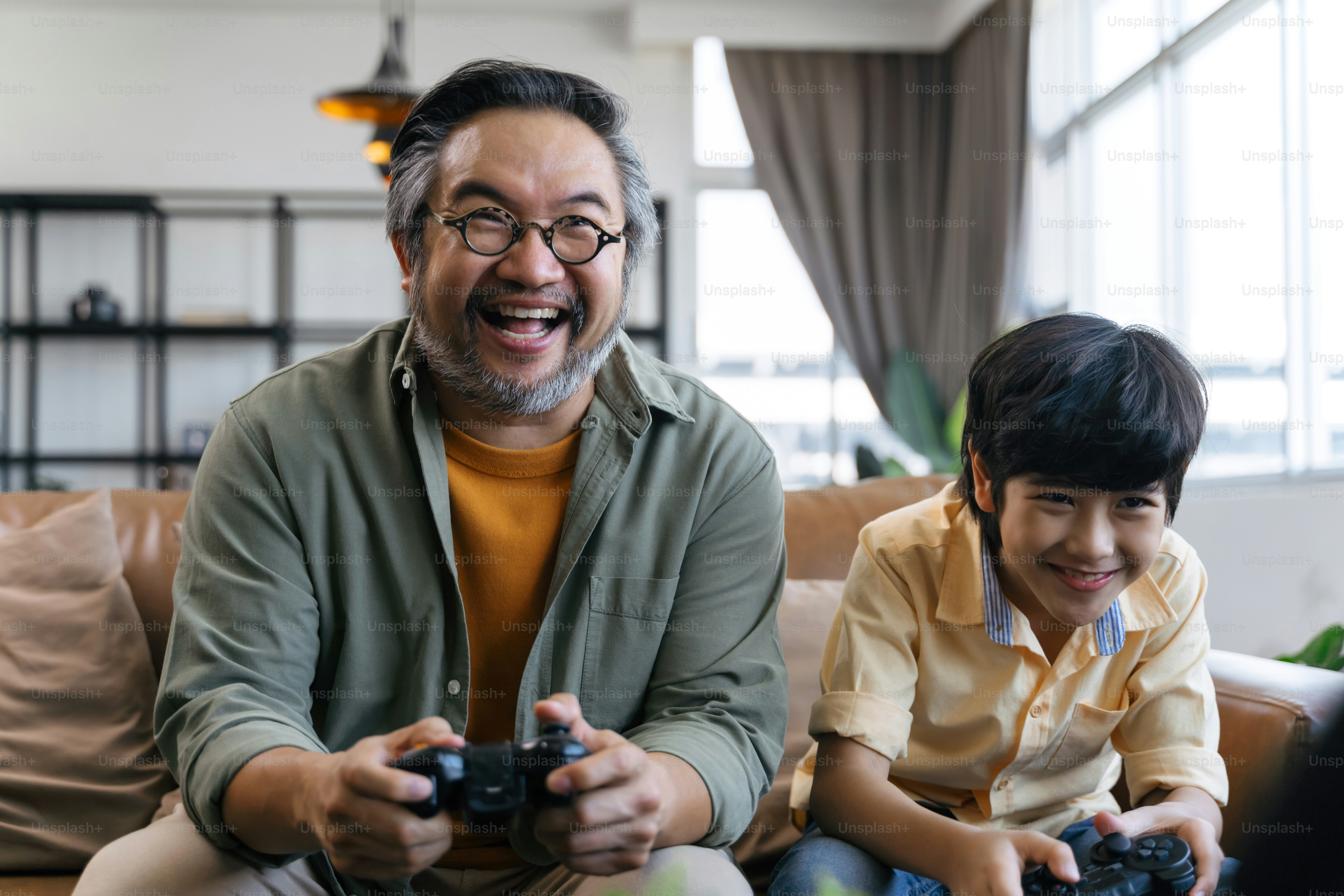 Son and dad playing video game at home photo – Video gaming Image on ...