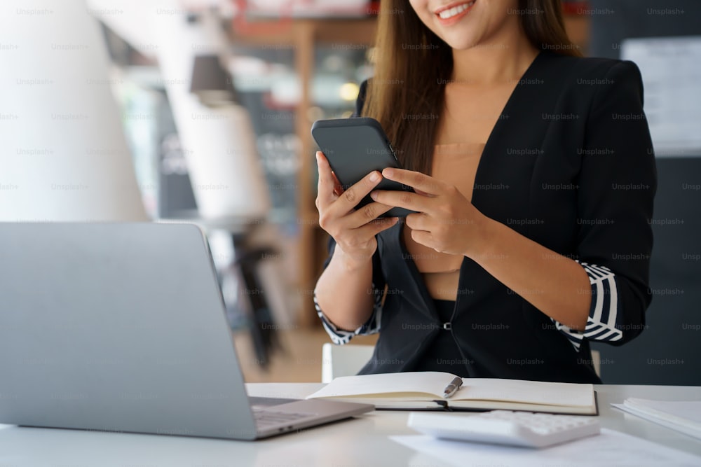 Woman using smartphone to send text , work or play social media.