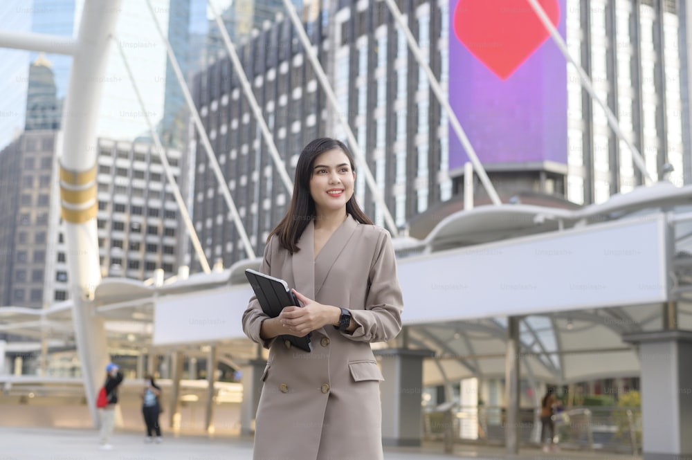 A young beautiful businesswoman is using tablet in Modern city , business technology , city lifestyle concept