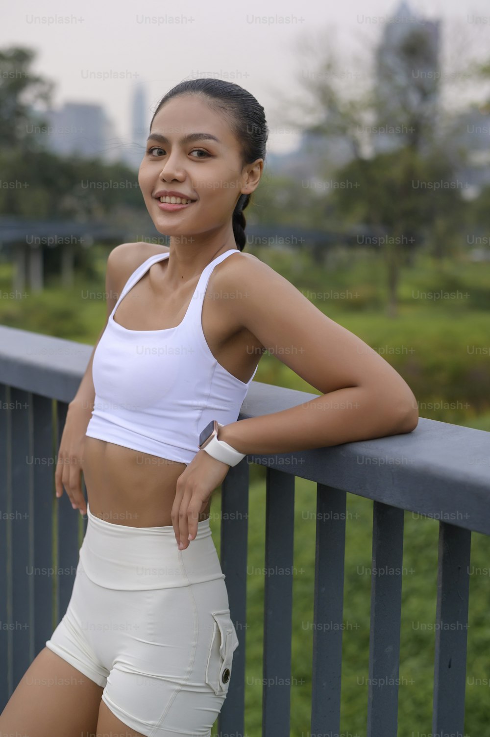 A portrait of young fitness woman in sportswear in city park, Healthy and Lifestyles.