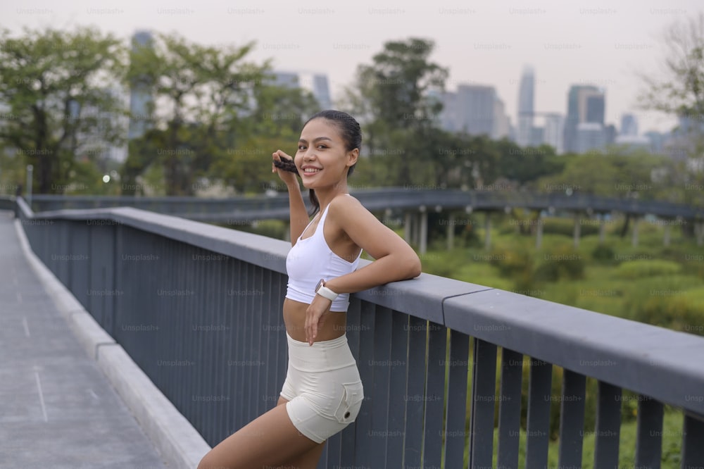 A portrait of young fitness woman in sportswear in city park, Healthy and Lifestyles.