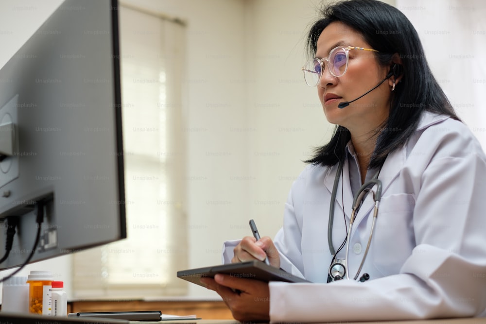 asian woman doctor visit patient video call online diagnose symptom at clinic