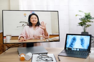 asian woman doctor visit patient video call online diagnose symptom at clinic