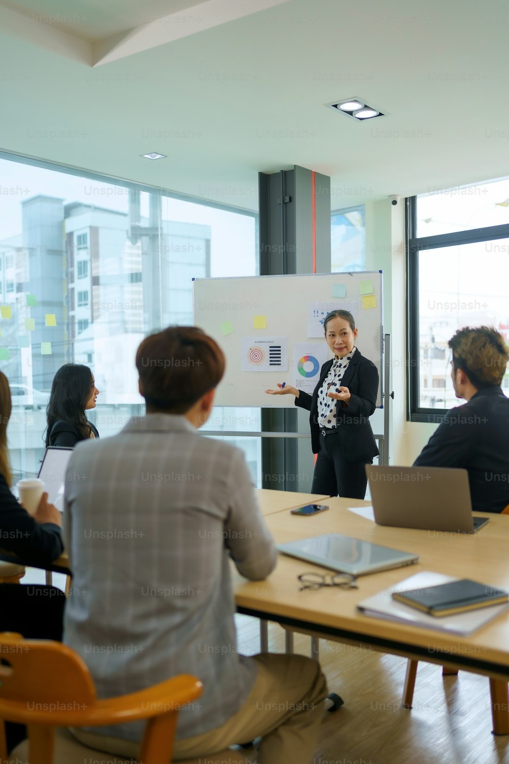 Treffen asiatischer Geschäftsleute, die sich der Arbeit verschrieben haben. Kreatives Business-Team sitzt zusammen im Büro.