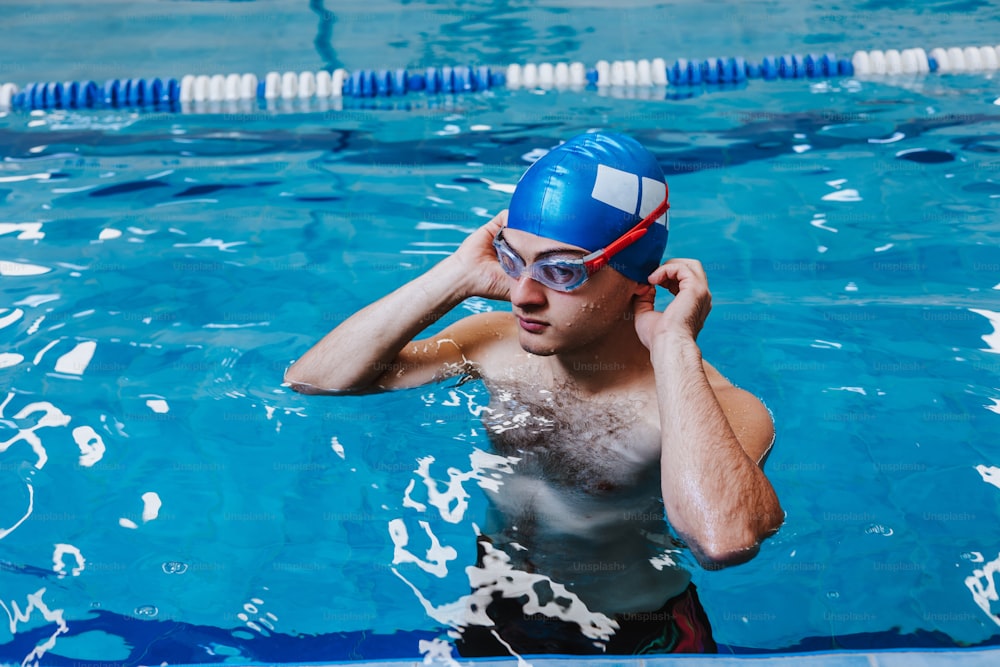 hispanic young man swimmer athlete wearing cap in a swimming training at the Pool in Mexico Latin America