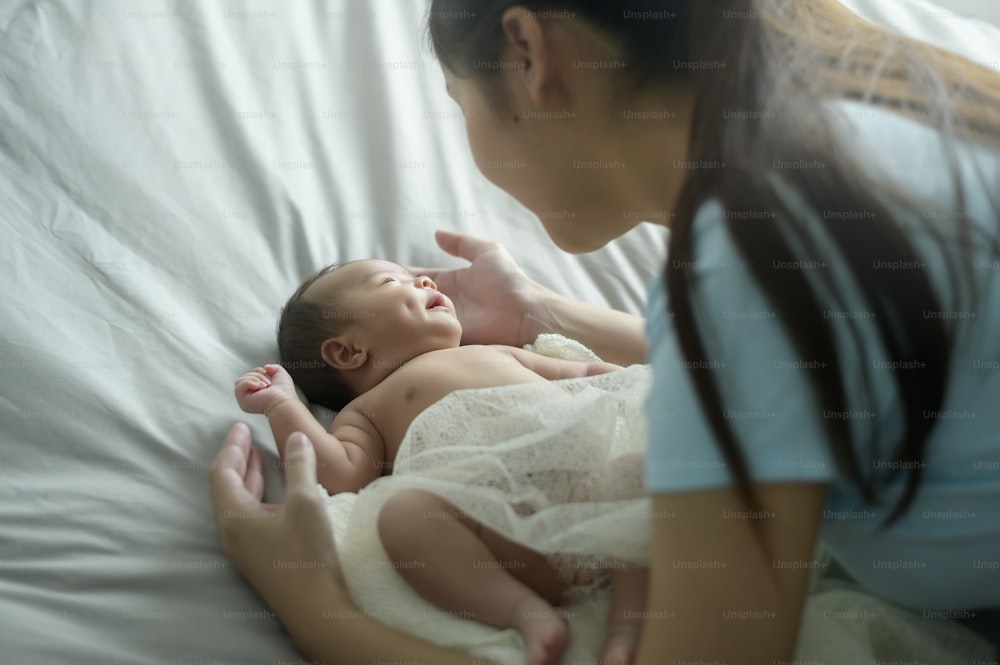 Uma jovem mãe com um bebê recém-nascido bonito.