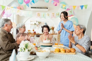 birthday party at senior daycare,group of asian female elder male female laugh smile positive conversation greeting in birthday friend party at nursing home senior daycare center Senior woman birthday
