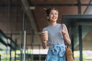 casual walking while business discussion at office corridor,asian female digital nomad freelance entrepreneur casual working while travel vacation outdoor corridor workplace,smiling female smartphone