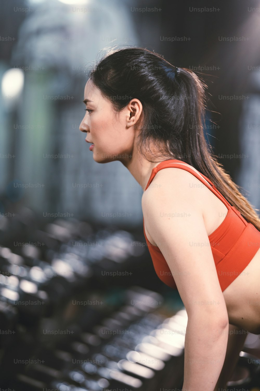 young Asian woman person exercise in fitness gym for building a beautiful slim body, healthy training of athletic female in sport lifestyle, attractive girl doing weight active wellness in happy