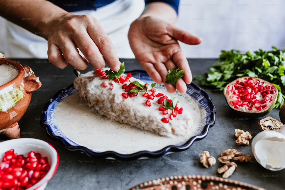 mexican woman cooking chiles en nogada recipe with Poblano chili and ingredients, traditional dish in Puebla Mexico