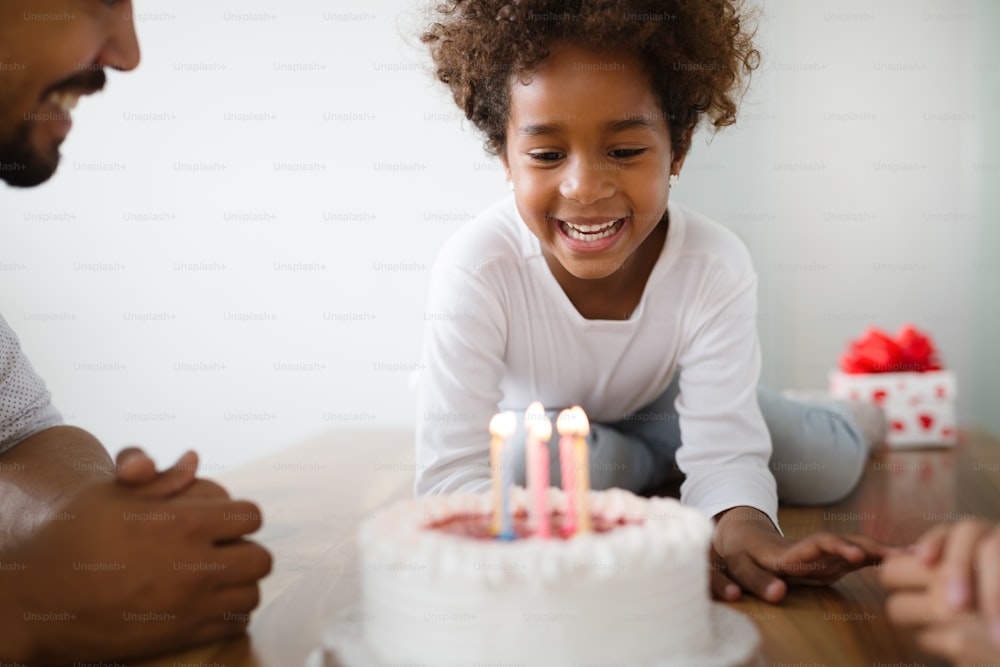 Happy family celebrating birthday of their child at home