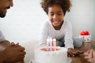 Happy family celebrating birthday of their child at home