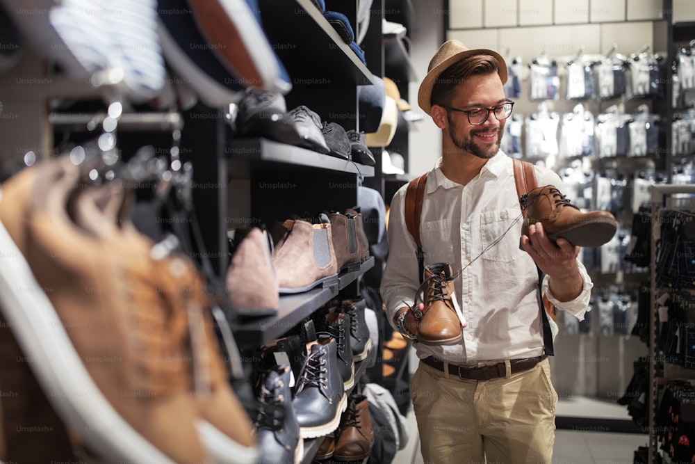 Portrait of a handsome young man shopping for clothes at shop