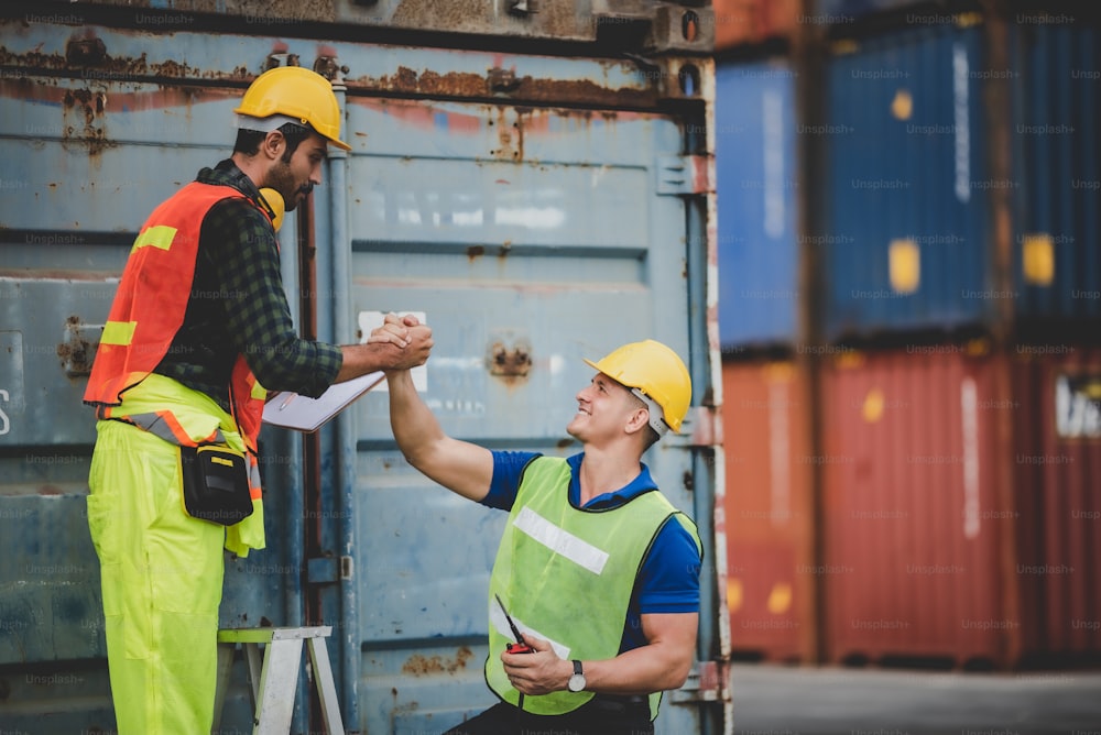 worker teamwork and partner of foreman, engineer, and businessman working in an international shipping area, concept of business industrial and working in container yard"t