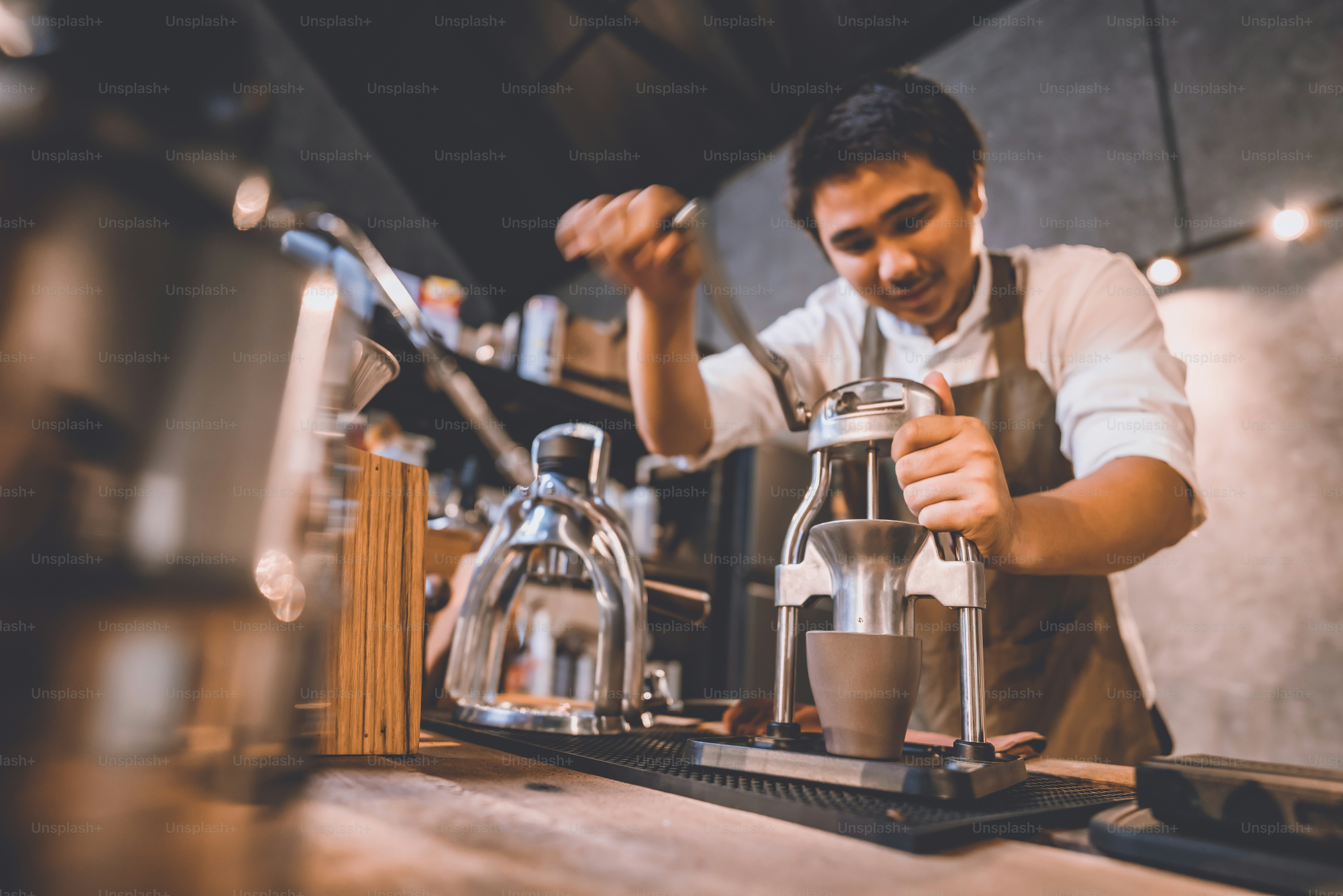 Professional barista making hot drink of a fresh coffee in vintage cafe ...
