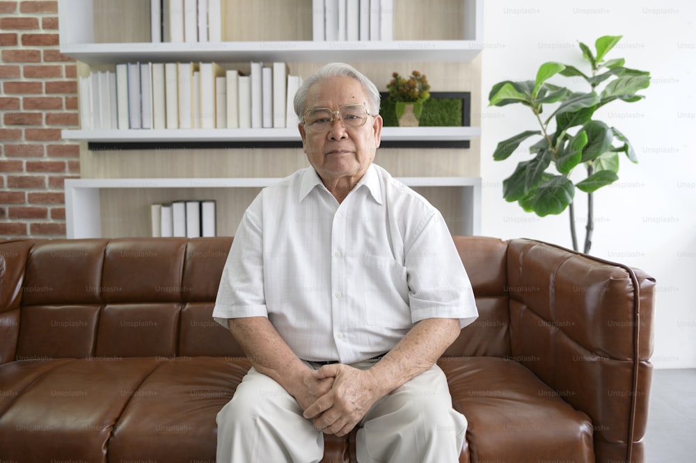 Senior Asian man making video call on social network with doctor consulting about health problems, head shot close up portrait.