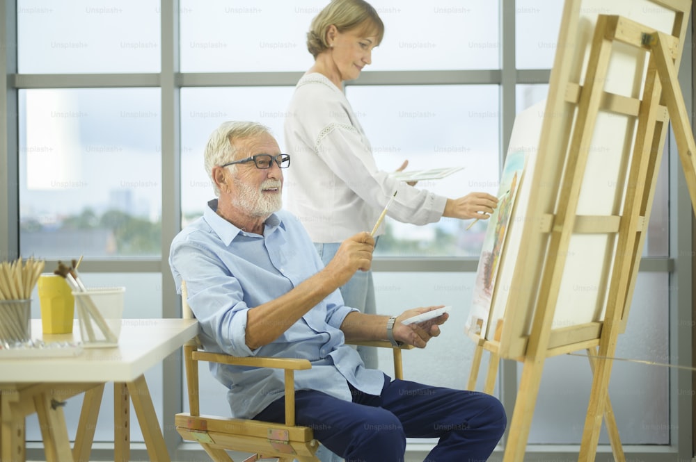 年配の白人カップルが家で絵を描き、リラックス