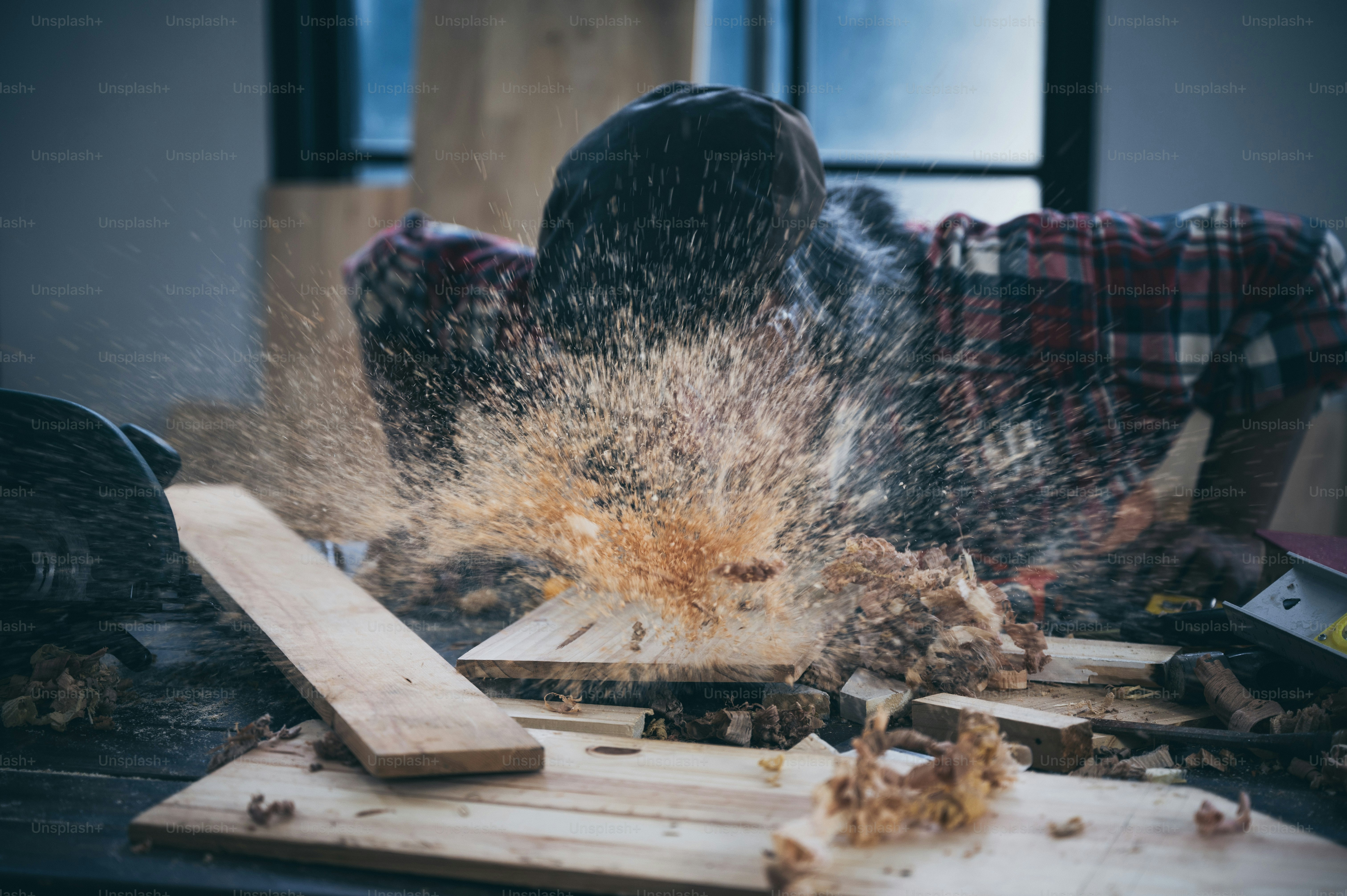 Background image of woodworking workshop: carpenters work table with different tools and wood cutting stand, vintage filter image