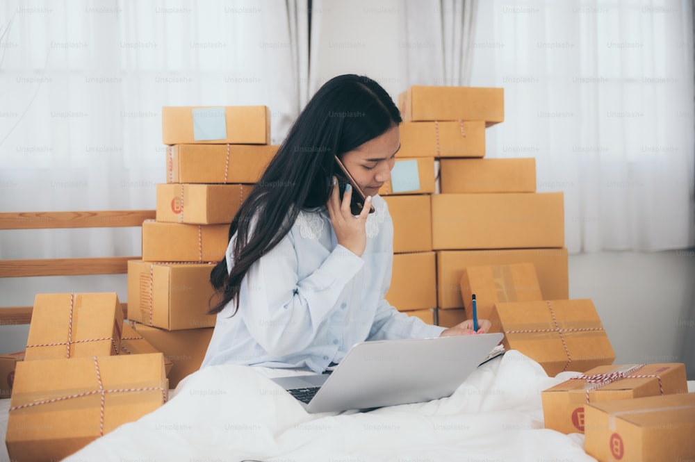 Young woman entrepreneur selling online product and use laptop in her workplace.