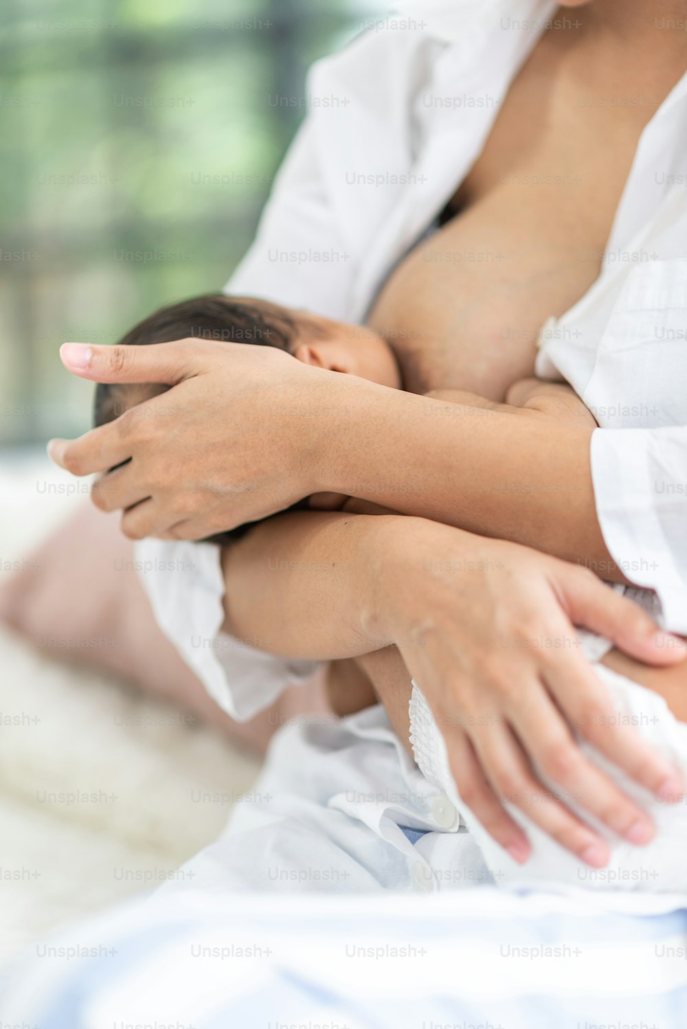 Una madre joven lleva a un bebé en brazos