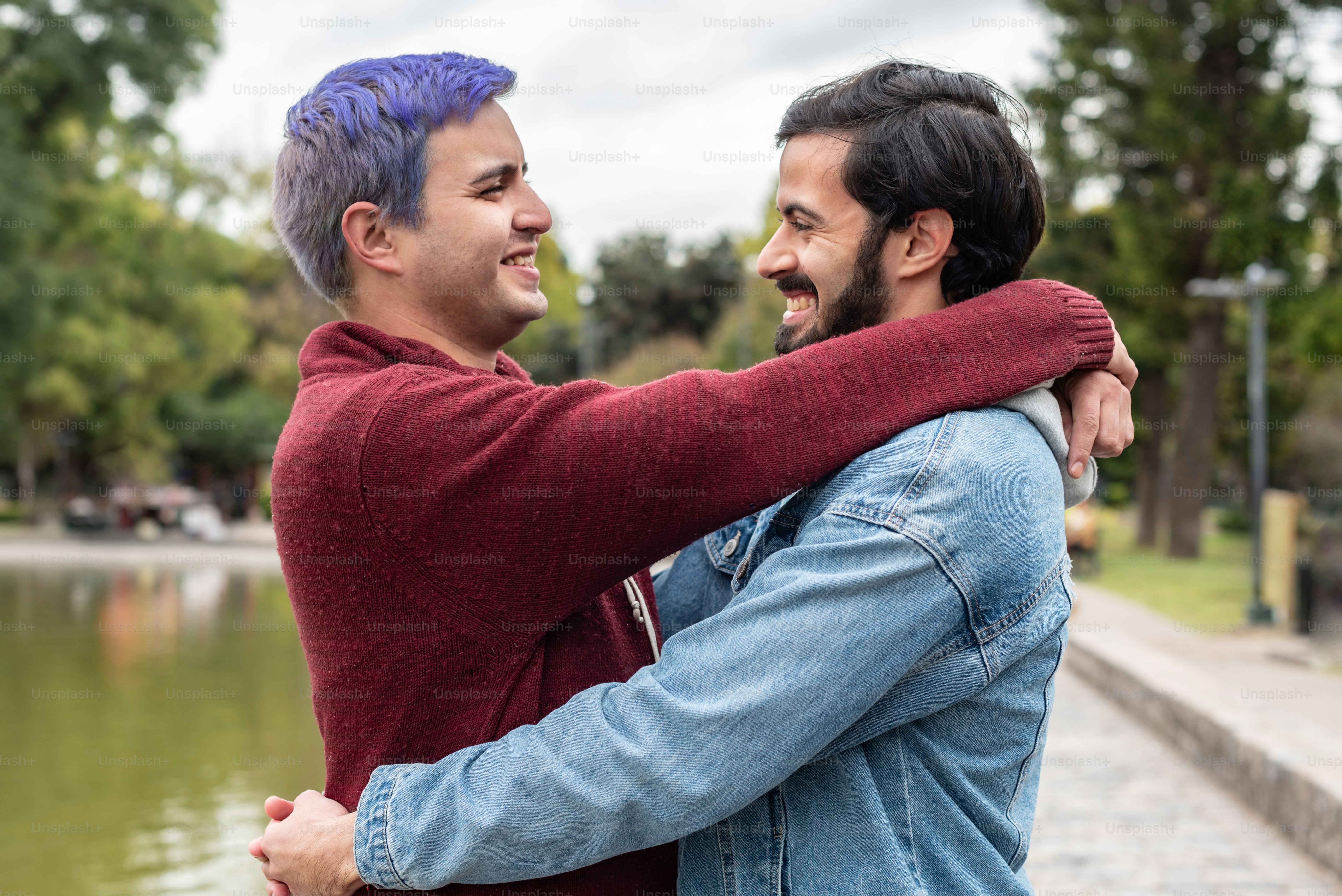 Gay male couple hugging and looking at each other. LGBT concept