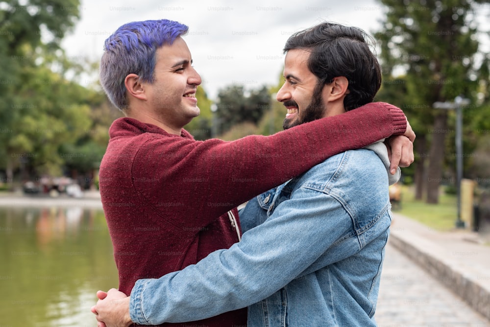 Gay male couple hugging and looking at each other. LGBT concept