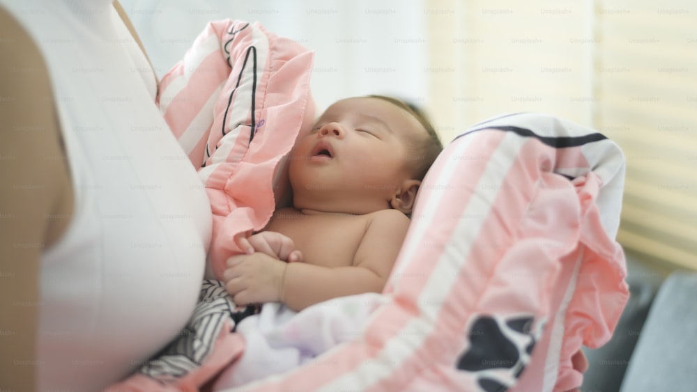 A Young mother with a Cute new born baby.