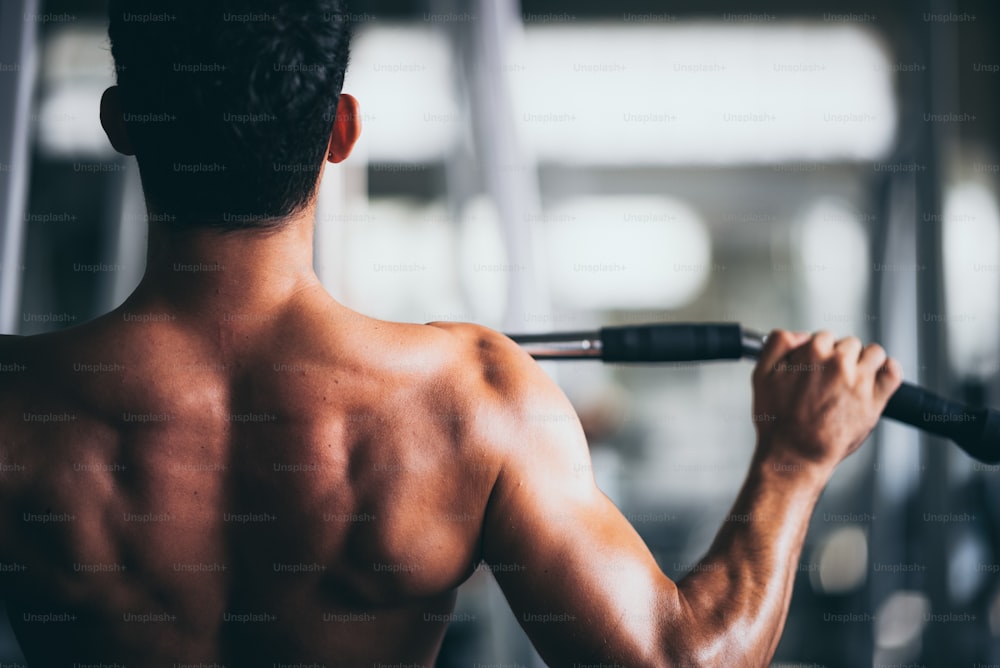 giovane persona di forma fisica eseguire l'esercizio con la macchina di esercizio in palestra