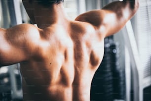 Strong man exercising in the sport gym