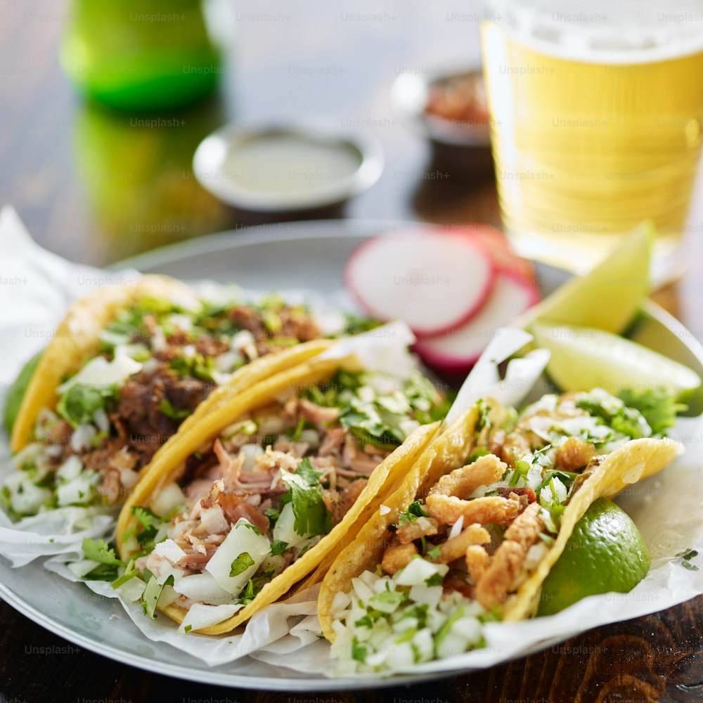 three types of mexican street tacos with barbacoa, carnitas and Chicharrón shot with selective focus