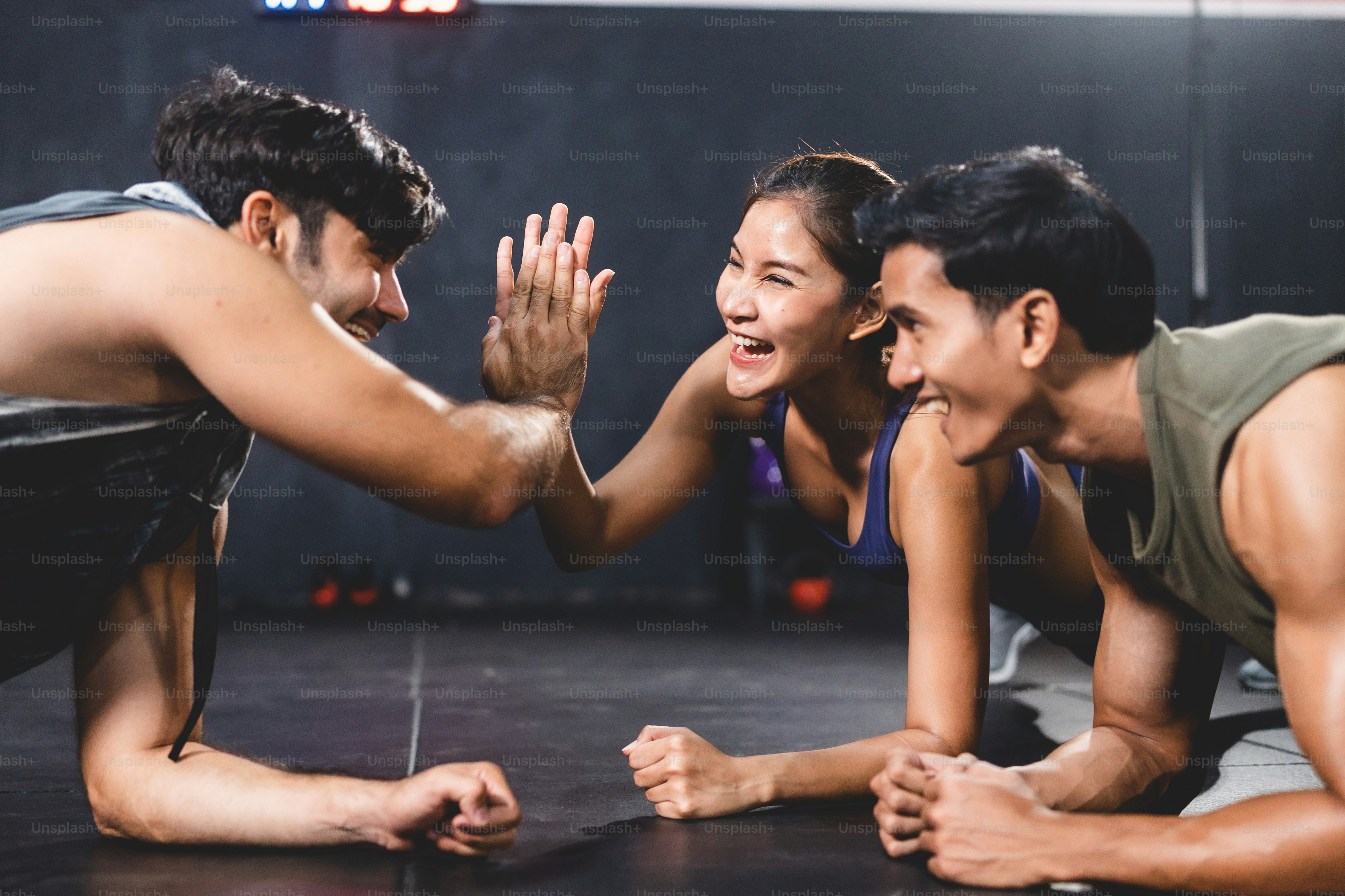 Personal trainer coach helping young woman exercising in the sport gym, exercise training workout in fitness, body healthy active in sport lifestyle, happy girl bodybuilding with sportswear