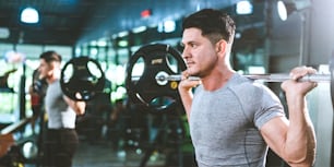 strong athlete man person exercising in modern sport gym, active workout exercise training in fitness studio for body strong power and heavy fit, bodybuilding and physical healthy lifestyle people