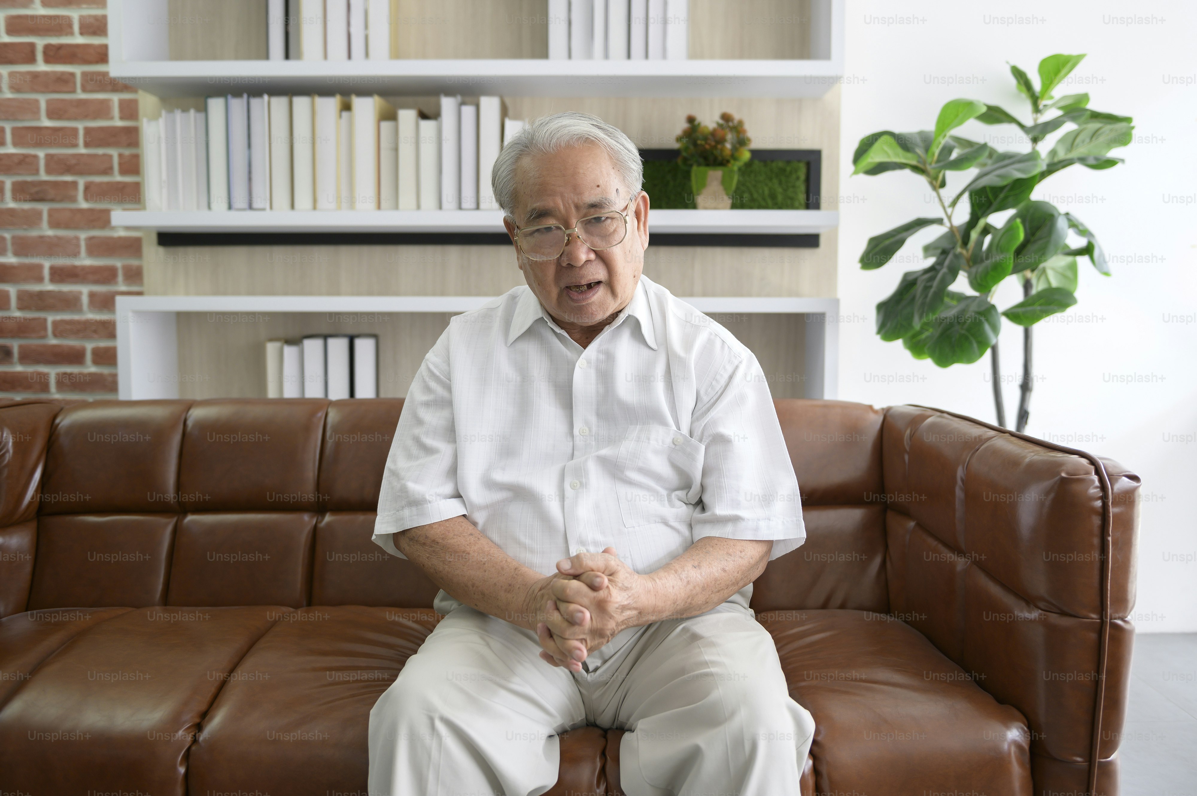 Senior Asian man making video call on social network with doctor consulting about health problems, head shot close up portrait.
