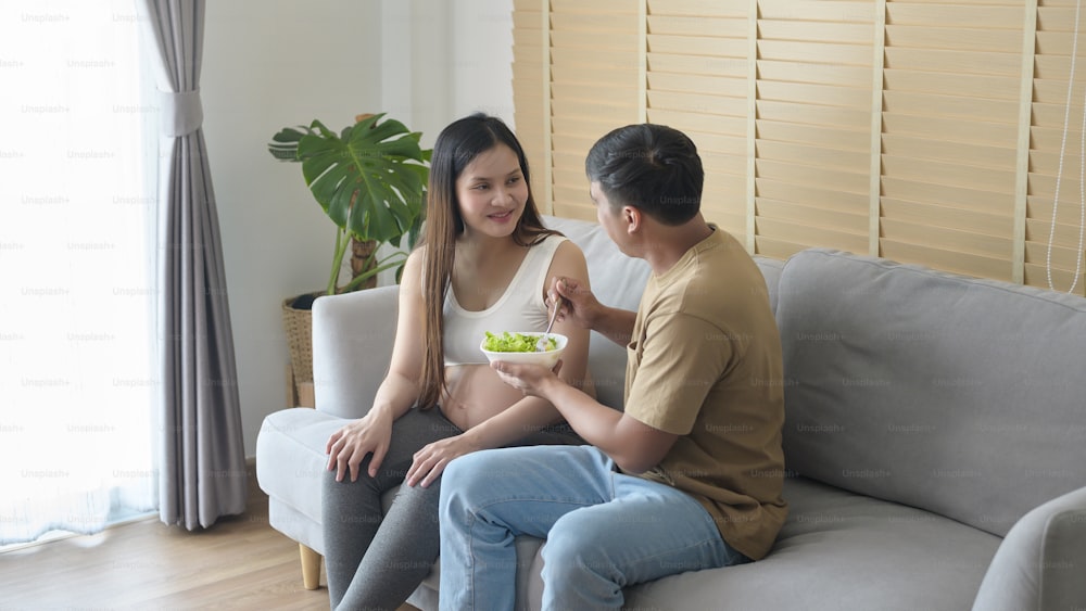 Young pregnant woman having salad at home, healthcare and pregnancy care