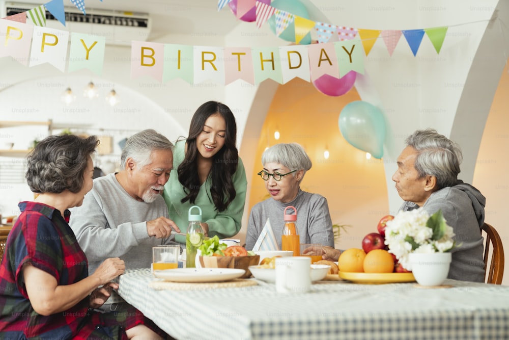 birthday party at senior daycare,group of asian female elder male female laugh smile positive conversation greeting in birthday friend party at nursing home senior daycare center Senior male birthday