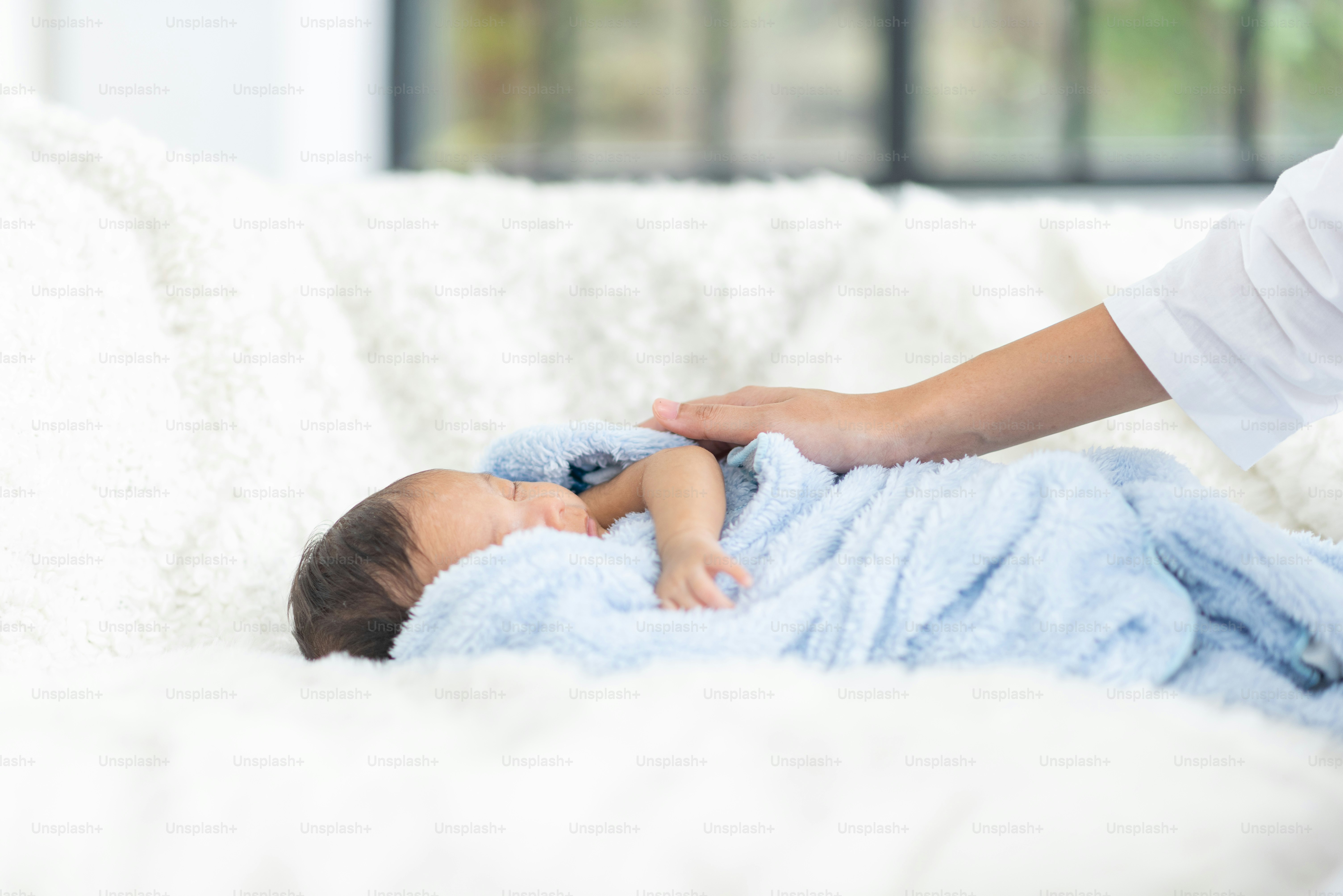 A young mother carries a baby