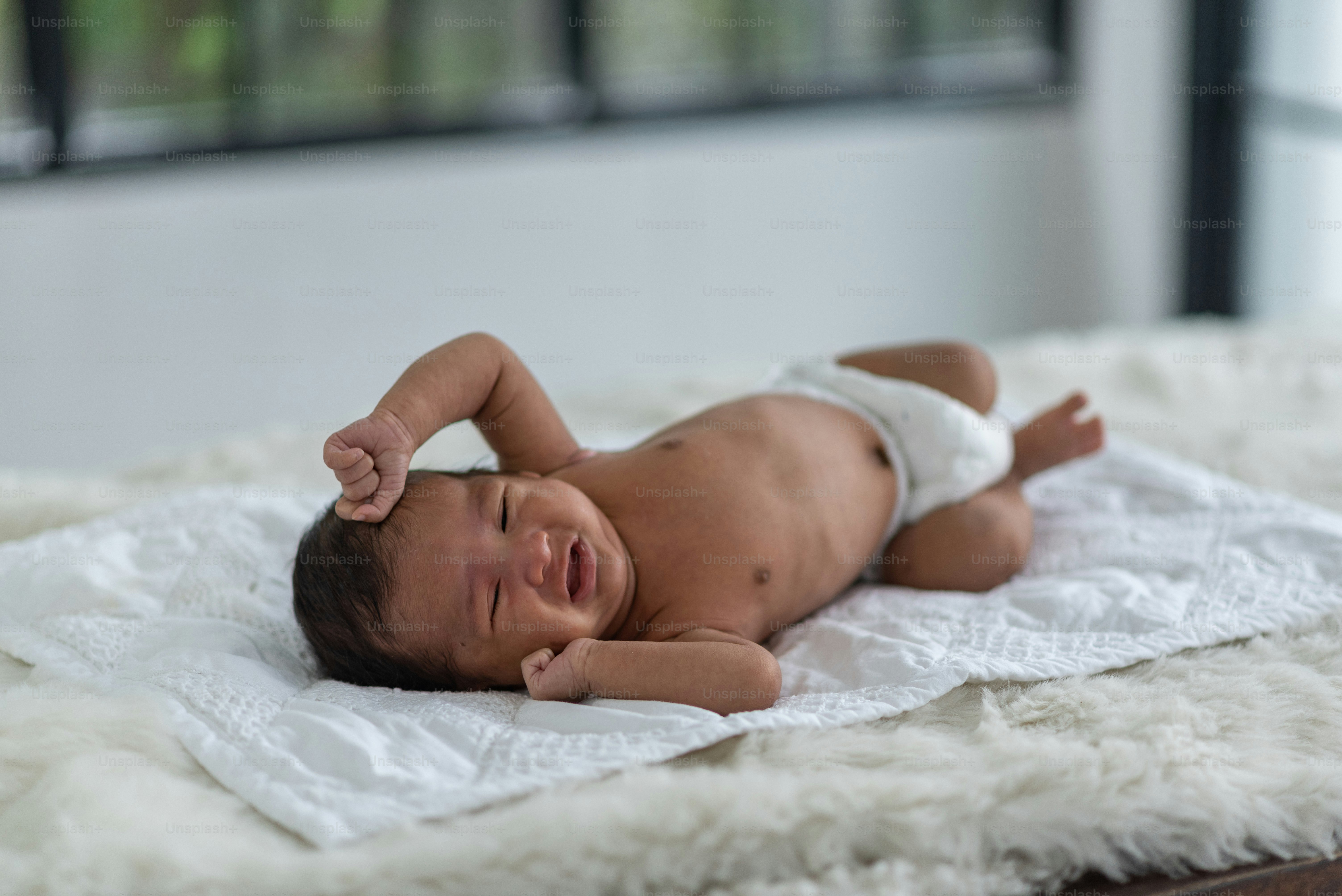 Newborn baby sleeping in bed