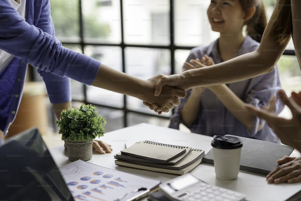 Business success. Business people shaking hands agreement confirmed in the investment business.